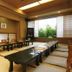 Kameya Ean in Izu, Japanese-style dining room with low tables, floor cushions, and a garden-view window.