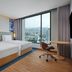 Hilton Garden Inn Bangkok Riverside guest room with twin beds and floor-to-ceiling city view in Bangkok