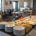Breakfast buffet at Kurort Stara Wedzarnia in Gdansk with plates, pastries, and dining tables