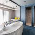 Colors Hotel Athens in Athens: suite bathroom with freestanding tub, twin walk-in showers and lounge area