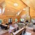 Franziska Haus, Dundee: spacious wood-paneled lodge living room with stone fireplace and dining area