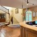 Relais De Margaux lobby with curved reception desk, staircase and arched windows in Margaux-Cantenac