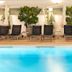 Kronos Hotel in Platamon indoor pool with black lounge chairs and potted trees