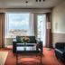 Arass Hotel & Business Flats Antwerp room with city view, sofa seating, dining table and large window