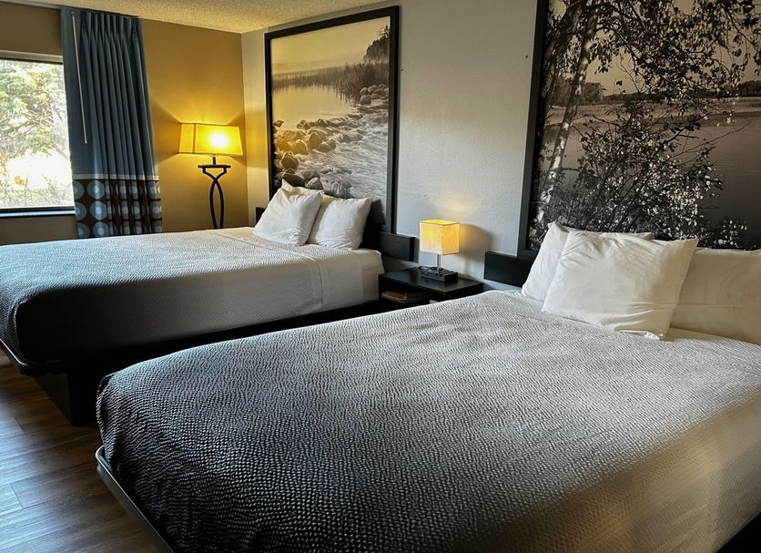 Super 8 by Wyndham Estherville room with two beds, bedside lamps, and a window view