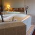 Regency Inn Richmond jetted tub in tiled bathroom with lamp and mirror