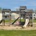Mackinaw Budget Inn in Mackinaw City playground with slides and swings on grassy grounds