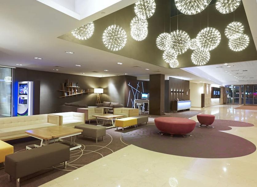 Novotel Warsaw Center lobby lounge in Warsaw with modern seating and hanging globe lights