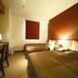 Business Hotel Cuore, Tsuruga guest room with two twin beds, desk, and window blind
