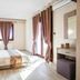 Mediterranean Holidays, Ierissós guest room with bed, vanity, and balcony doors with curtains