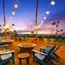 Hilton Garden Inn Kauai Wailua Bay in Kapaa: sunset ocean-view patio with chairs and string lights