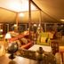 Lake Elmenteita Serena Camp in Nakuru, luxury tented lounge with warm seating and chandeliers