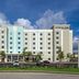 TownePlace Suites by Marriott Naples exterior with palm trees and parking lot under a blue sky