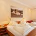 Family & Sporthotel Kärntnerhof room with double bed and mountain view in Bad Kleinkirchheim