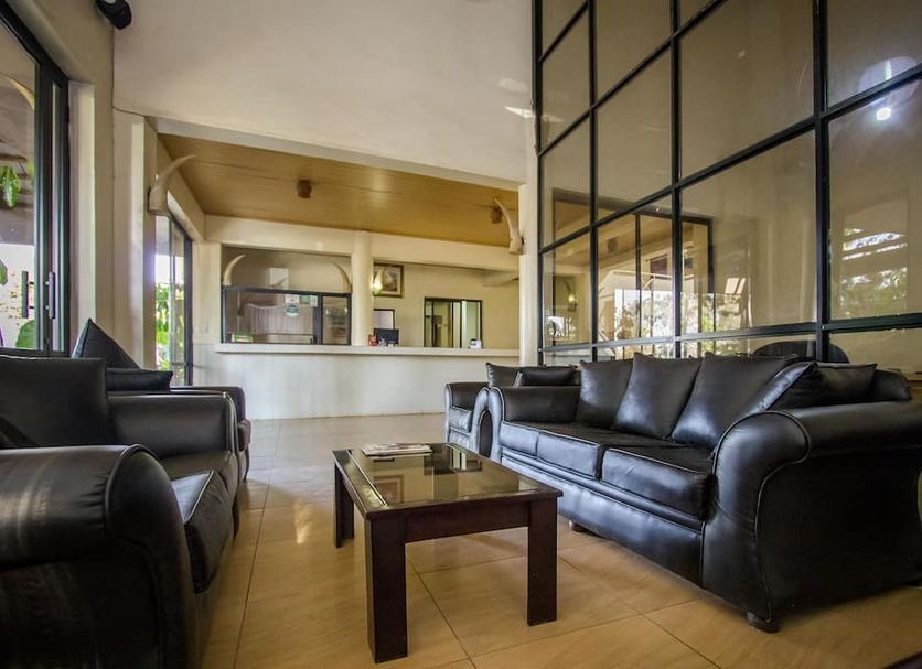 Park Place Hotel Nairobi lobby with black leather sofas, glass coffee table, and large windows