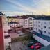Linköpings Cityhotell och Vandrarhem in Linköping, exterior view at sunset with parking area and nearby buildings
