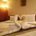 Ao Nang Beach Resort in Krabi: swan towel art on a neatly made bed in a guest room