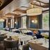 Seda Club Hotel in Granada dining room with set tables, upholstered chairs, and large windows