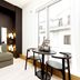 Wilde Aparthotels London Covent Garden room with seating nook and table by a large window in London.