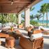 Rosewood Mayakoba in Playa del Carmen features an open-air beachfront lounge with ocean views and palm trees.