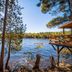 Motel Long Lake and Cottages on Long Lake with lakeside cabin deck and waterfront pine trees