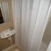 The Bull And Bush Hotel Kingston bathroom with sink, mirror and shower curtain in Kingston upon Thames