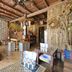 Songphuamia Guesthouse in Chiang Khan lobby with wooden tables, stools and bamboo decor