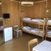 Charlottsborgs Vandrarhem Kristianstad dorm room with bunk beds, small fridge, and mirror