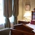Alaska Heritage House Bed And Breakfast room in Fairbanks with a carved wood bed and bedside lamps
