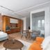 Le Merrill - Vieux Montréal studio suite with bed, kitchenette, dining table and brick accent wall in Montreal