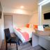 Wild Orchid Villa Bangkok guest room with double bed, desk chair and wall-mounted TV in Bangkok