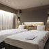 Richmond Hotel Obihiro Ekimae in Obihiro room with two twin beds and warm wall lighting