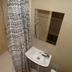 The Bull And Bush Hotel Kingston bathroom with shower, sink, and patterned curtain in Kingston upon Thames