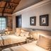 La Alondra, Casa de huéspedes in Corrientes: cozy guest room with two beds, exposed brick, and tall windows