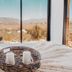 Contemplacion Resort & Spa in Ensenada with bed facing a desert mountain view through large windows