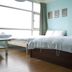 Light Morning in Yuchi Township guest room with twin beds and large window overlooking water