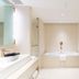 The Bauhinia Hotel - Central bathroom with bathtub, glass shower, and vanity in Hong Kong