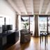 Hotel del Porto in Torri Del Benaco suite with balcony doors, lake view, sofa, chair, and TV