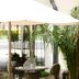Hotel du Vin Bristol in Bristol outdoor patio dining area with wicker chairs and large umbrella