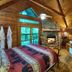 A Cabin In The Woods in Pigeon Forge with log bed, hot tub, and deck view