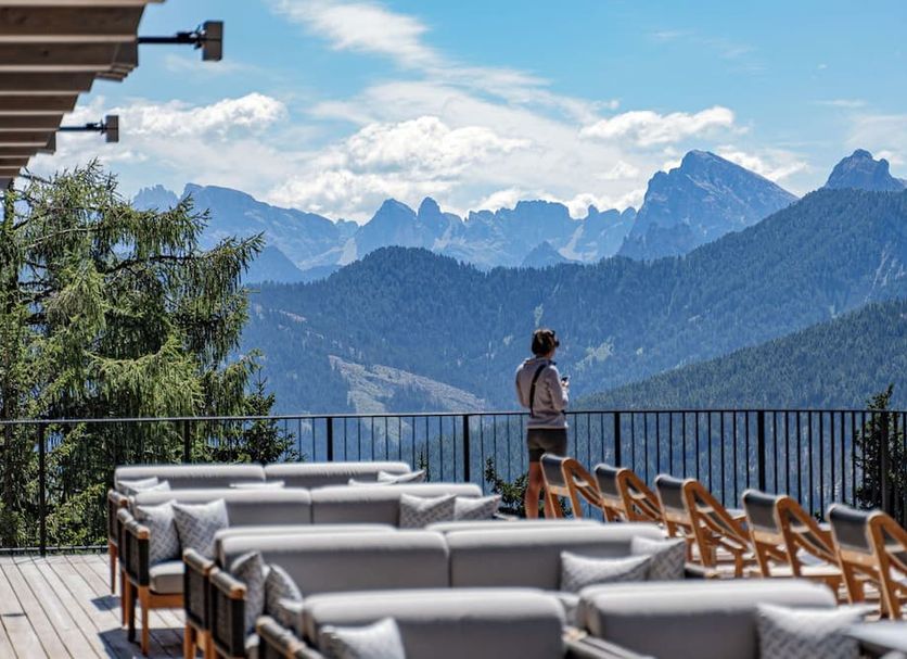Hotel Olangerhof in Valdaora terrace with lounge seating and mountain views
