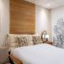 The Goose House Ubon in Ubon Ratchathani: guest room with bed, wall art, and bedside lamp