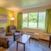 Parkwood Lodge, Fish Creek guest room with two recliners and a window view of green lawn