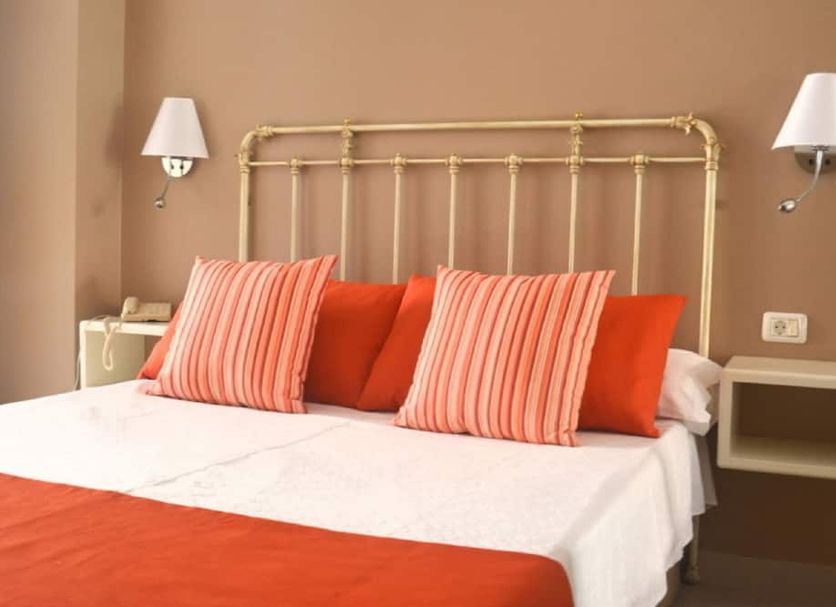 RF Astoria - Only Adults room with brass bed, coral pillows and wall-mounted lamps in Puerto de la Cruz