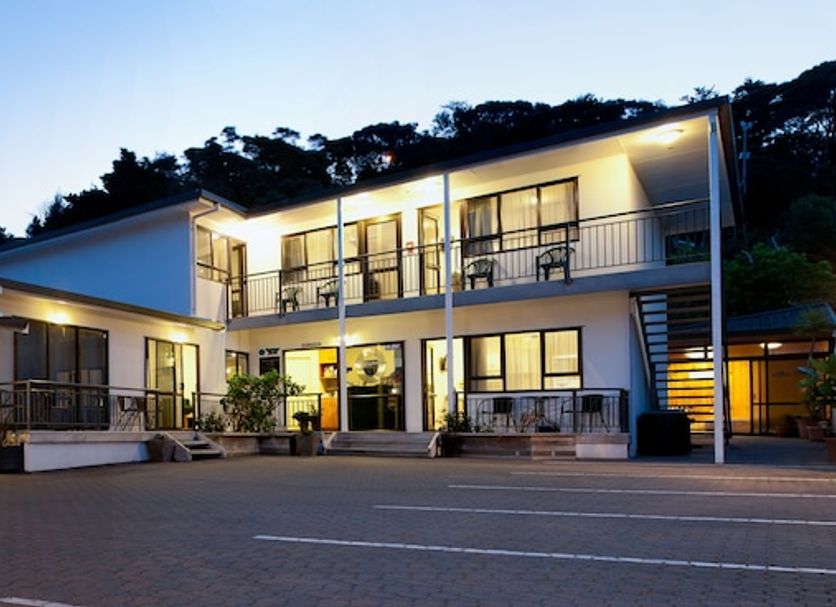 Outrigger Motel in Paihia exterior at dusk with lit rooms and courtyard
