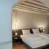 Alter Schlachthof Bressanone/Brixen guest room with twin beds under an arched doorway