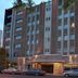 Austral Bahia Blanca Hotel in Bahía Blanca, brick hotel exterior at dusk with lit entrance and street view