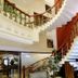 Hotel City Heart Premium in Chandigarh interior staircase with curved railing and lobby seating area