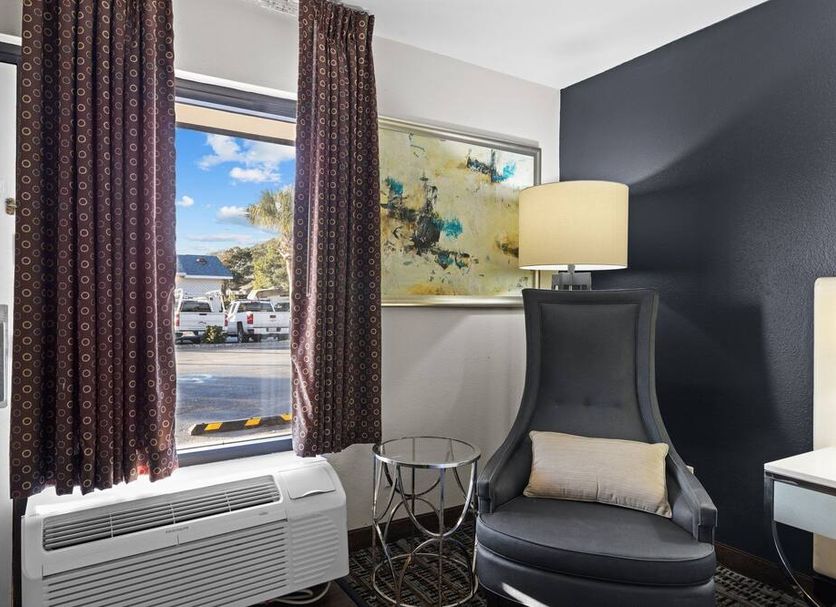 Garnet Inn & Suites, Morehead City room with window view, armchair, lamp and small table