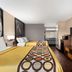 Super 8 by Wyndham Universal City room with two beds, desk, TV and microwave